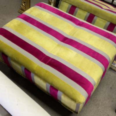 A modern upholstered footstool.