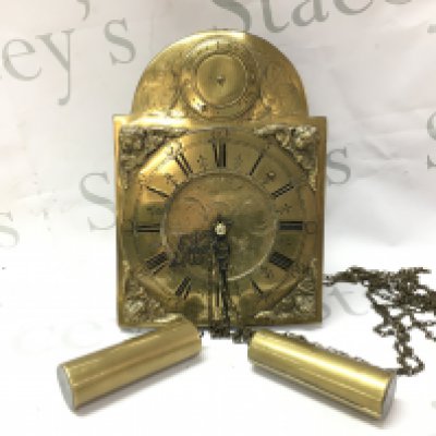 A German brass wall clock with weights . Postage category C