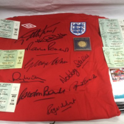 A signed England 1966 World Cup replica shirt plus six tickets from the same championship and a commemorative coin. Shipping category B.