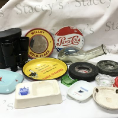 Vintage items including a ceramic Wade Johnnie Walker ashtray, Mackenzie scotch whiskey ashtray, double diamond tray, wills gold flake cigarettes mirror, Pepsi cola sign , tyre ash trays, Cheiza Zenith 12x50 binoculars ,glass urinal bottle. This lot cannot be posted