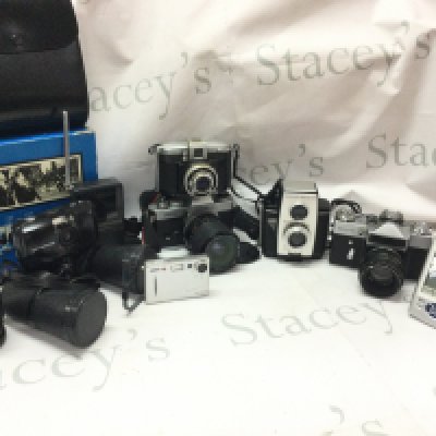 A collection of cameras including Brownie Reflex 20, Zenit-E, Yashica Fr II, Olympus , Mark Scheffel 10x50 binoculars, Casio EV-500, Ferrania. Postage category C