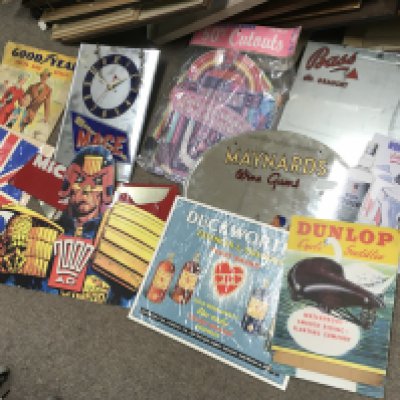 A collection of advertisements including Bass on draught and Maynard wine gum mirrors, 2000AD judge dread cardboard advertisement, Duckworths sign, Dunlop cycle saddles cardboard standee, Mage mirror clock, Michelin tyre display stand . We cannot post this lot.