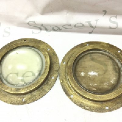 Two vintage brass portholes , thick glass. 22cm wide. This lot cannot be posted