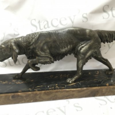 Art Deco spelter figure of a gun dog on a marble base 27.5cm tall 60cm wide.
