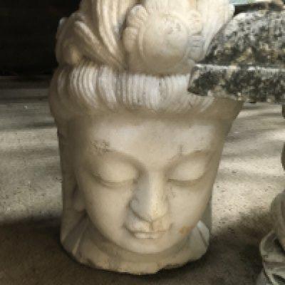 A stone bust carving in the form of a deity . 50 cm .