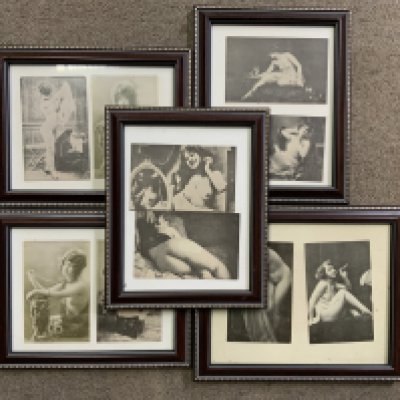 A collection of framed nude subject postcards.
