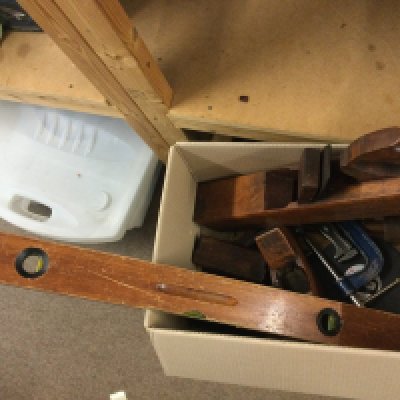 A collection of tools including wooden planes, Stanley steel plane, etc
