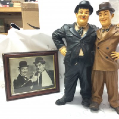 A Laurel And Hardy figure group and a framed photo