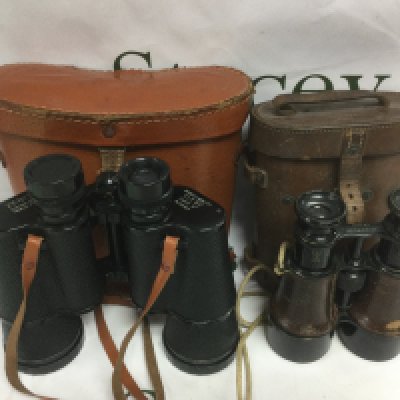 Two pairs of binoculars comprising an early 20th Century Hezzanith example and a later Zenith model (2). Shipping category D.