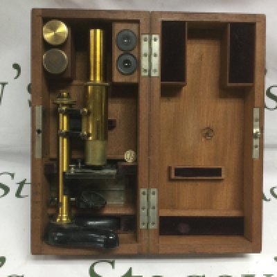 A cased Baird & Tatlock microscope and lenses. Shipping category D.