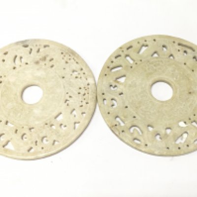 Two Chinese carved and pierced jade bi discs