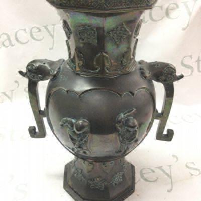 A Chinese twin handled bronze vase decorated with musician figures and figures at a lake scene, 37cm tall approximately. Postage category C