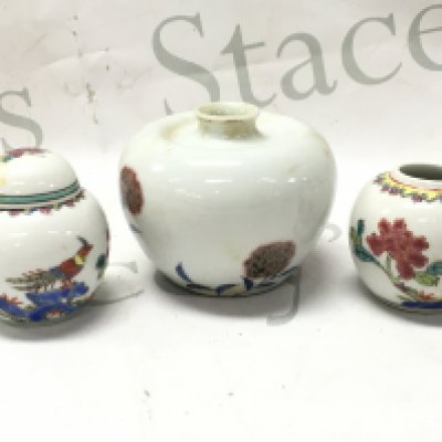 Three small Chinese jars including a pair of Famille rose jars (6cm tall 6cm wide), largest vase with a six character mark at base (8cm tall 9cm wide). This lot cannot be posted