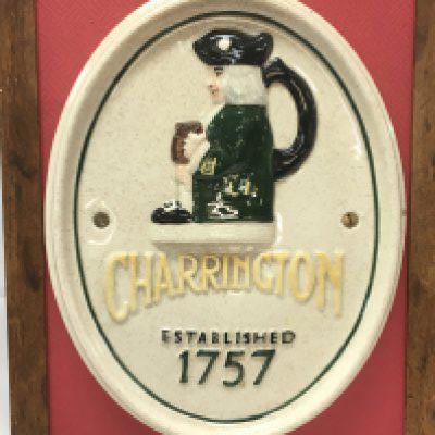 A porcelain Charringtons advertising plaque on a hanging frame . This lot cannot be posted