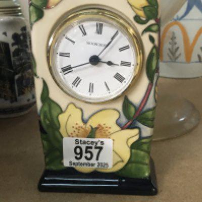 A Moorcroft clock decorated with floral design.