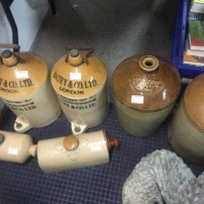 Four stone ware flagons and two hot water bottles