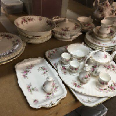 A Royal Albert Lavender rose dinner tea set including tea cups saucers dinner plates serving plates tureens serving plates and bowls .