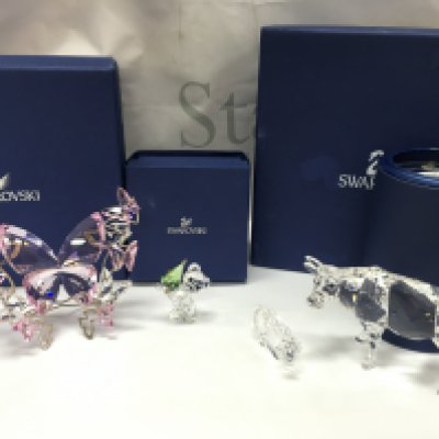 Four boxed Swarovski Crystal items including Kris bear Christmas, Large Rosaline butterfly , Zodiac lion, cow. Postage category B
