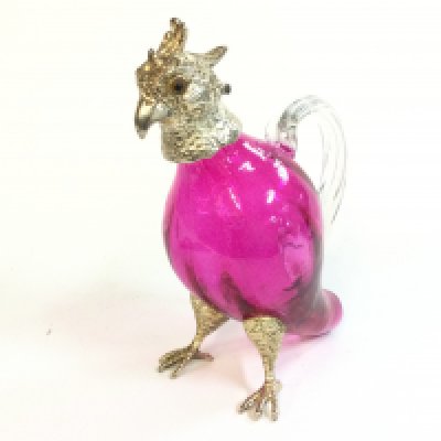 A cranberry glass parrot cockatoo decanter, 17cm tall . This lot cannot be posted