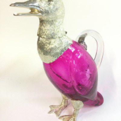 Cranberry glass duck claret jug decanter , 26cm tall .