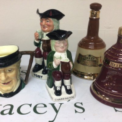 Two fubottles of Bells Whiskey Toby and Charrington caricature jugs and others.