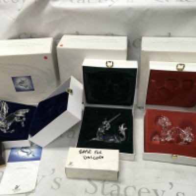 Three Swarovski Crystal fabulous creature figurines. All in boxes with their stands. One stand without its box and note very slight damage on ear of unicorn.