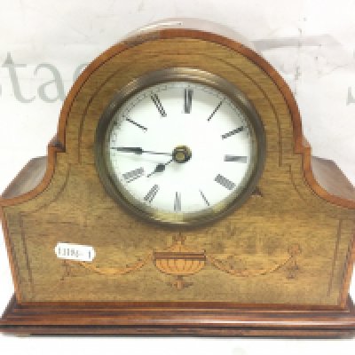An Edwardian mantle clock with a French movement , inlaid design and key . Seen working. Dimensions 25 cm tall 21 cm wide. This lot cannot be posted- NO RESERVE