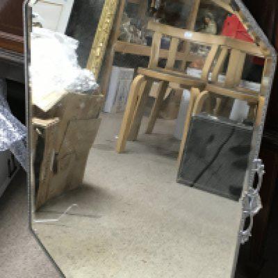 A bevelled edge mirror 49cm wide 75cm tall. No reserve