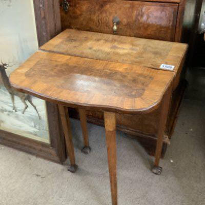 A small walnut veneered occasional table. 48cm x 22cm x 70cm. (In need of restoration). NO RESERVE