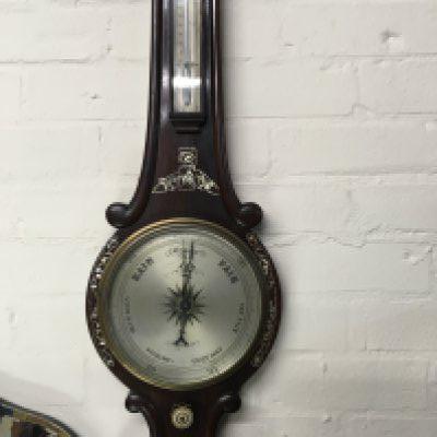 A rose wood barometer inlaid with mother of Pearl .