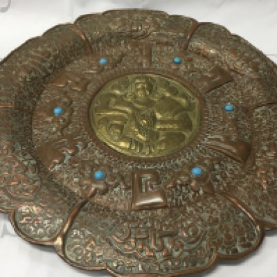A Tibetan bodhisattva wall plaque inset with turquoise. Diameter 35cm.- NO RESERVE