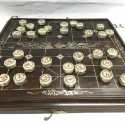 A Chinese board game inset with mother of pearl decoration. Shipping category C.