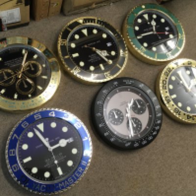 Six Rolex style battery operated novelty wall clocks . 34cm wide approximately
