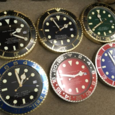 Six Rolex style battery operated novelty wall clocks . 34cm wide approximately