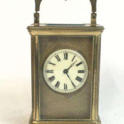 A brass clock , with key , seen working . Dimensions 11cm tall , 7.5cm wide. This lot cannot be posted