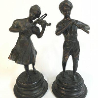 A bronze pair of figures a girl playing a violin and boy with flute , 25cm tall. Postage category c