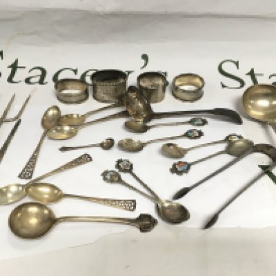 A collection of silver cutlery and napkin rings. Shipping category B.