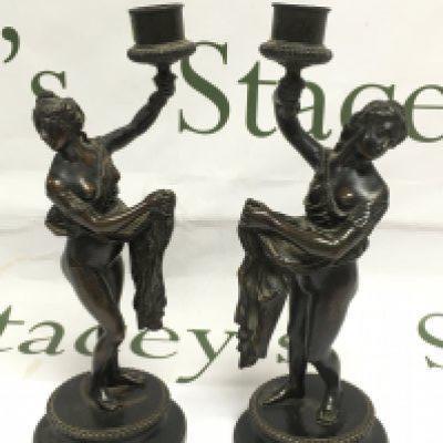 A pair of bronze figural candlesticks, approx 24cm. Shipping category B.