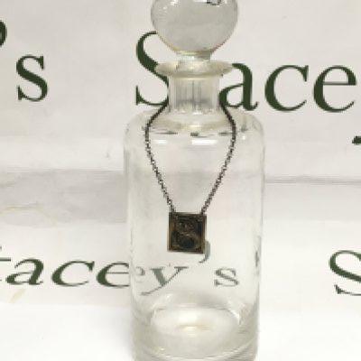 A glass wine decanter with a Georgian silver sherry label. Shipping category D.