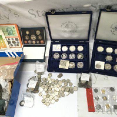 A large collection of assorted world coinage including sterling silver commemoration coins and pre 1946 coinage. Postage C