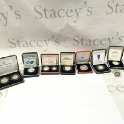 A collective lot of silver coins including silver proof fifty pence set. Postage B