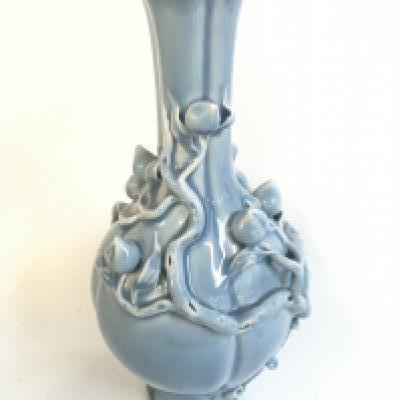 A Chinese porcelain blue powder with peach blossom relief vase , with a six character mark at base. 32cm tall approximately