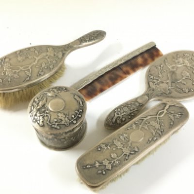 Chinese cherry blossom silver dressing set including a brush, comb, mirror, container.