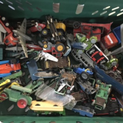 Box of small vehicles such as trains, planes, cars, trucks and more. Dinky toys and diecast vintage toys.