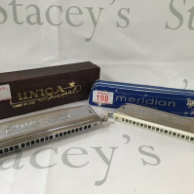 Meridian stage pro harmonica, and a Tombo Unica De Luxe formal harmonica