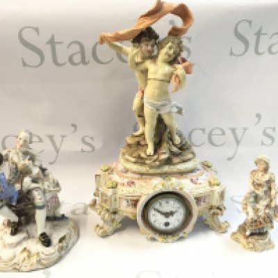 A Collection of German classical style porcelain figures including a porcelain mantle clock with a mounted figure group