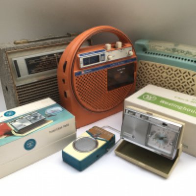 A box of vintage radios including HMV, GEC and others examples.
