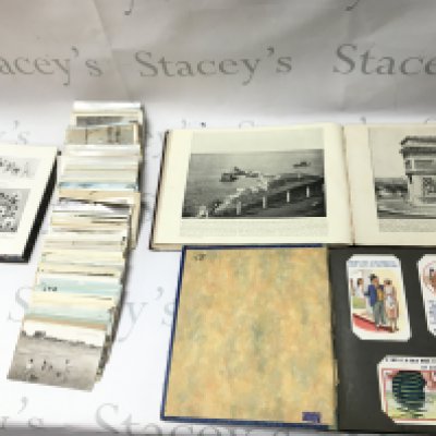 A collection of post cards photographs and books.