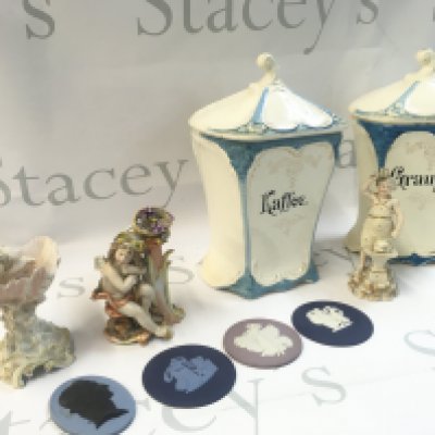 Porcelain coffee jars, German classical style porcelain figures and Wedgwood oval miniature panels.