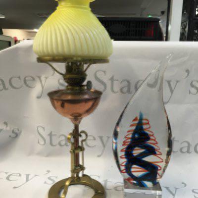 An art glass decorative piece/ paperweight and a copper/brass oil lamp with yellow glass shade